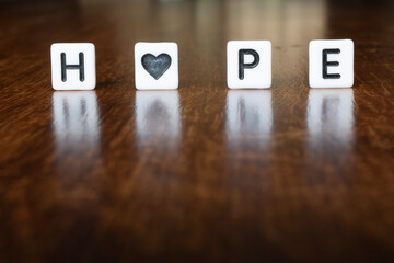 HOPE text word message in 3D with heart symbol. Hope word written on a block.