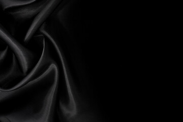 Part of the dark fabric texture of the fabric for the background and decoration of the work of art, a beautiful crumpled pattern of silk or linen. A crumpled piece of cloth