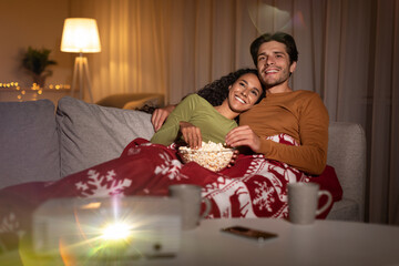 Happy Family Couple Watching Christmas Movies Film At Home
