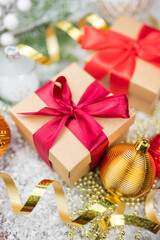 Christmas decor with decorations balls on a Christmas tree with serpentine and gift boxes with surprises