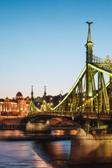 A panoramic view of the Liberty Bridge and buildings in Budapest. Colorful evening view in Budapest, Hungary, Europe.