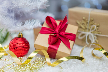 Christmas decor with decorations balls on a Christmas tree with serpentine and gift boxes with surprises