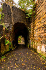 Old ruined walls of a tunnelled walkway in St. James Cemetery next to Liverpool cathedral in England