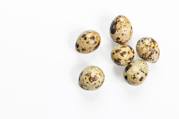 Rustic quail eggs are isolated on white. Copy space. Place for text