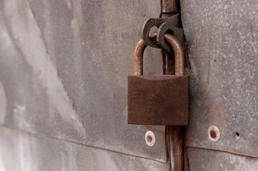 brown rusty lock on metal doors