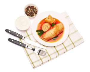 Portion of cabbage rolls stuffed with ground beef and rice with sour cream on a plate