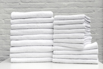 a lot towel white cleaning laundry hotel housemaid stack clean hand woman