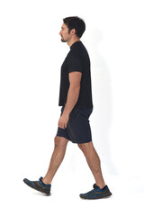 side view of man wearing sportswear walking on white background