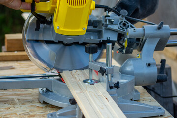 Sawing a board with a miter saw