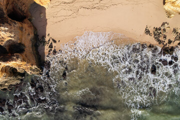 Beach and waves from top view. Turquoise water background. Summer seascape from air. Portugal Lagos Algarve. Travel concept and idea