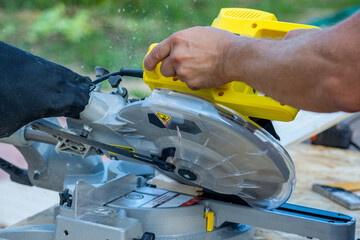 Sawing a board with a miter saw