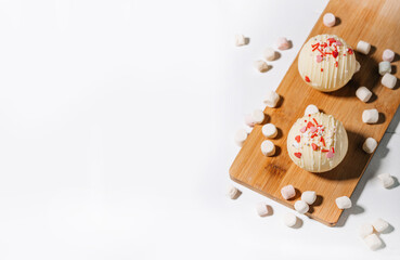 Cocoa bombs with marshmallows, chocolate that melts when hot milk is added for creating a trendy...