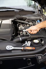 Fototapeta na wymiar Mechanic examining and maintenance the engine a vehicle car hood