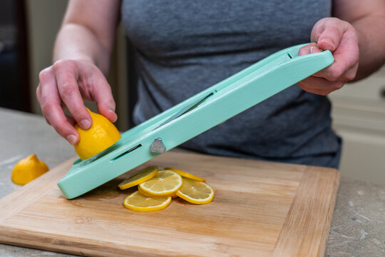 Woman slicing on a mandolin 