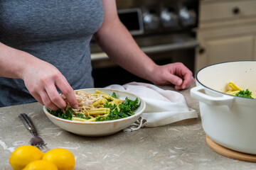 Woman making healthy pasta meal 