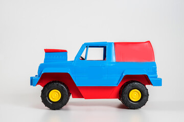 Multi-colored plastic children's toy cars on a white background.