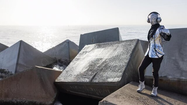 Mr disco man with sparkly face dancing on rocks