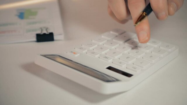 The hands of an accountant work on a calculator and prepare a financial report hd stock footage