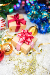 Christmas decor with decorations balls on a Christmas tree with serpentine and gift boxes with surprises