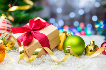 Christmas decor with decorations balls on a Christmas tree with serpentine and gift boxes with surprises