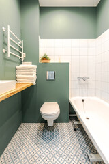 Minimalistic elegant design of bathroom in wormwood green color, installation, white bath. Wall...