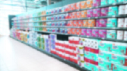 Abstract blur image of supermarket background. Defocused shelves with paper towels roll and toilet. Store. Retail industry. Rack. Environmental price. Inflation and economic crisis concept. Aisle.