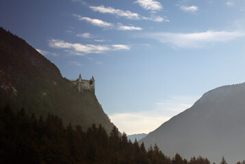 A castle from fairy-tale on a mountain against blue sky