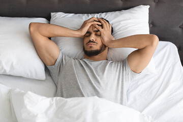 Restless Young Arab Guy Waking Up In The Morning With Headache
