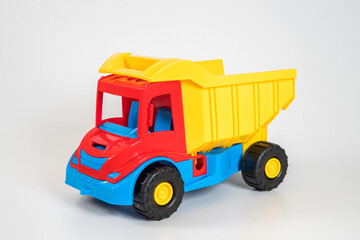 Naklejka premium Multi-colored plastic children's toy cars on a white background.