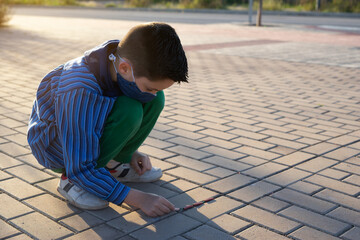Kid playing with chinesse firecrackers called petardos in popular valencian fallas festivals