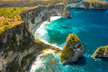 Aerial shot at rocks formation with turquoise sea water at Atuh beach tropical paradise of Bali island.
