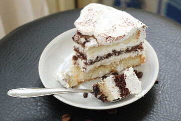 Closeup piece of chocolate cake cheesecake dessert sugar food eat tasty nobody table spoon coffee beans bakery delicious brown