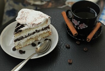 Closeup piece of chocolate cake cinnamon and cup of coffee cheesecake dessert sugar food eat tasty nobody table spoon coffee beans bakery delicious brown
