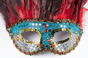 Paris, France - 11 22 2021: Packshot of Masked woman. A colorful mask with feathers and glitter