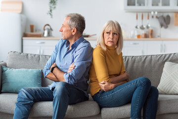 Offended Senior Couple Sitting Back-To-Back Having Marital Crisis At Home - obrazy, fototapety, plakaty