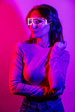 Young Woman In Projector Lights with led futuristic glasses