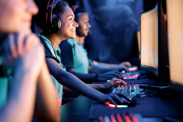 Selective focus on young African woman pro gamer having live stream and playing in online video game at computer club © Yaroslav Astakhov