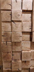 A fragment of a wall made of asymmetrical wooden cubes.