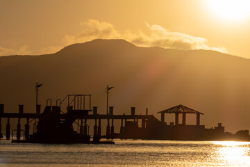 beautiful sunset on the beach, beautiful view of the calm waters of the sea, multicolored sky, mountains in the background