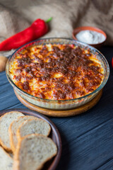 casserole lasagna dish with cheese baked on wooden background