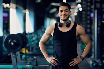 Fototapeta na wymiar Portrait Of Handsome Young Muscular Middle Eastern Man Posing In Gym