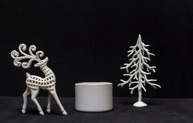 Minimal new year or christmas concept, stone podium with deer and christmas tree on black...