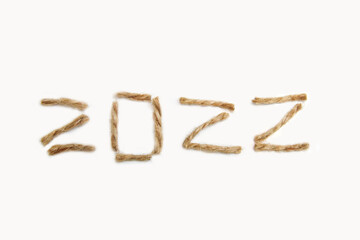Happy New year 2022. New Year Concept welcoming New Year 2022 written by craft rope on white background. Close-up. Two thousand twenty two