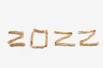 Happy New year 2022. New Year Concept welcoming New Year 2022 written by craft rope or jute on...
