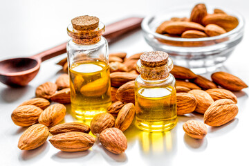 organic cosmetic with almond extract on table background