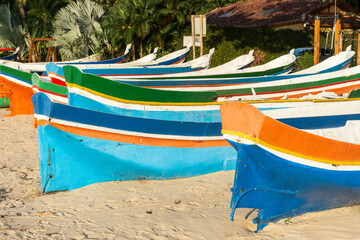 Beautiful view to colorful fishing canoes on tropical beach © Cavan