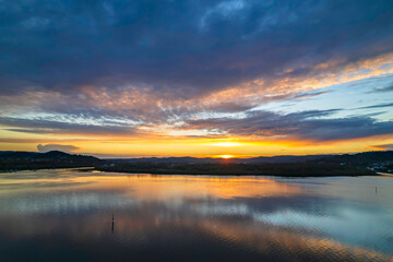 Sunrise aerial waterscape over the bay with cloud cover