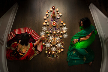 Indian Women doing a rangoli for Diwali 