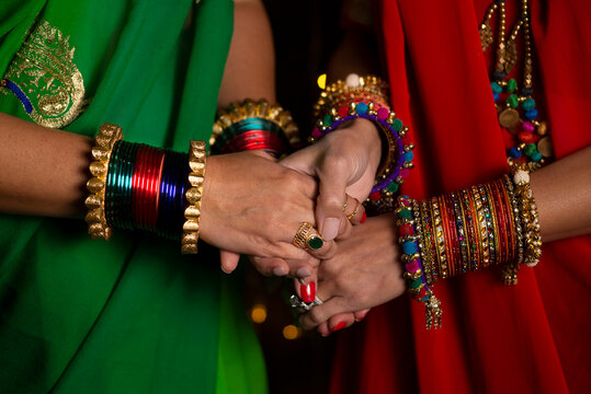 Woman holding hands with traditional Indian bangles 
