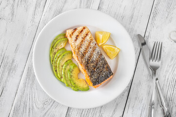 Fried salmon with avocado slices